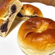 A plate of two Anpan, a traditional Japanese sweet bread filled with red bean paste