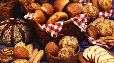 A selection of various breads elegantly arranged on a table, showcasing different shapes and textures