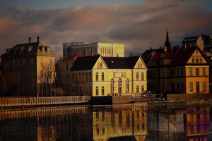 A panoramic view of a large body of water in Reykjavik, reflecting the city's skyline and surrounding landscapes
